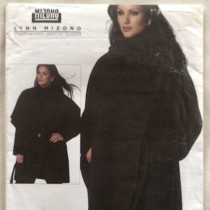 May include: A black coat pattern with a V-neck and a long, flowing design. The pattern is for sizes X-Small, Small, and Medium. The pattern is from Vogue Patterns and is designed by Lynn Mizono.