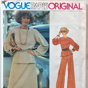 May include: A vintage sewing pattern for a women's outfit by Givenchy. The pattern includes a blouse with long sleeves and a skirt or pants. The pattern number is 1221.