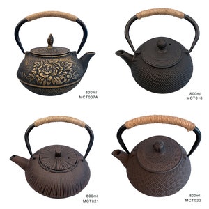 May include: Four cast iron teapots with different designs. The teapots are black, brown, and have a rope handle. The teapots are labeled with their size and model number. 800ml MCT007A, 800ml MCT018, 800ml MCT021, 800ml MCT022.