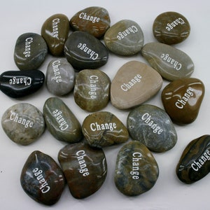 May include: A collection of smooth, gray, brown, and black stones with the word "Change" inscribed on each one.