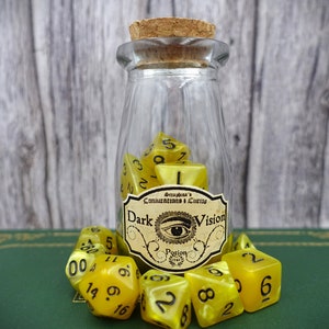 May include: A glass bottle with a cork stopper filled with yellow dice. The bottle has a label that reads "Conjurations & Curios Dark Vision Potion".
