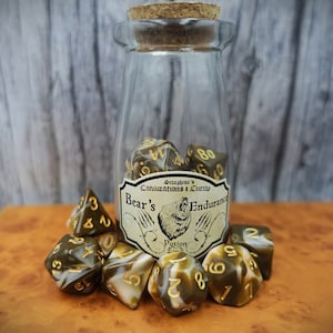 May include: A glass bottle with a cork stopper filled with brown and white dice. The bottle has a label that reads "Seraphina's Concoctions & Curios Bear's Endurance Potion".