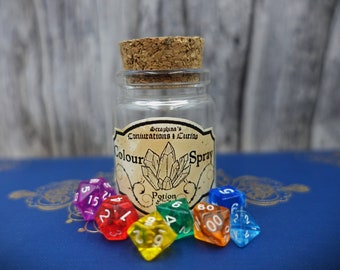 May include: A small glass bottle with a cork stopper and a label that reads "Seraphina's Conjuratons + Curios Colour Spray Potion". The bottle is surrounded by six colorful dice.