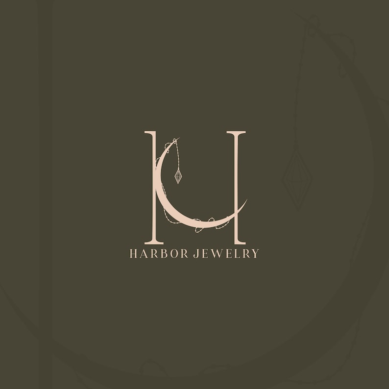 Harbor Jewelry custom logo design — elegant serif monogram HJ with crescent moon and hanging diamond pendant. Luxury jewellery brand identity by 90Designs.