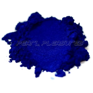 May include: A close-up of a pile of deep blue mica powder. The powder is fine and shimmery, and it is perfect for adding a touch of sparkle to any project.