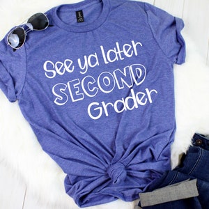 May include: A blue t-shirt with the text "See ya later Second Grader" in white lettering.