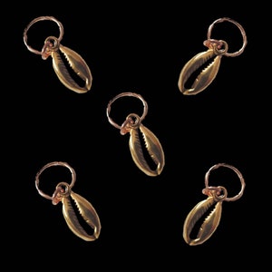 May include: Five gold-colored shell charms with a ring attached to each. The charms are in the shape of a seashell.
