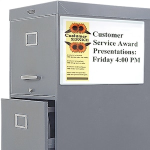 May include: A gray metal filing cabinet with an open drawer. A sign on the cabinet reads "Customer Service Award Presentations: Friday 4:00 PM" with sunflower graphics and text about customer service.