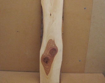 Live edge red cedar board with funky knots and a lot of white sap wood.