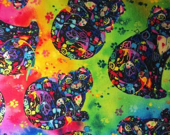 May include: A colorful fabric with a repeating pattern of black cats with rainbow paint splatters. The background is a tie-dye pattern of yellow, green, blue, and red.