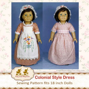 May include: Two dolls wearing colonial style dresses. One doll is wearing a brown dress with a white apron embroidered with flowers. The other doll is wearing a pink dress with a floral pattern. Both dolls are wearing white bonnets. The text says "Colonial Style Dress" and "Sewing Pattern fits 18 inch Dolls".