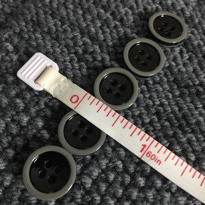 Set of 5 black with gray edge 4-hole buttons -- buy 4 sets get 1 set free