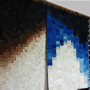 May include: Three different cowhide rugs with geometric patterns. The first rug is a gradient of brown to white, the second rug is a gradient of blue to white, and the third rug is a black and white pattern of circles.