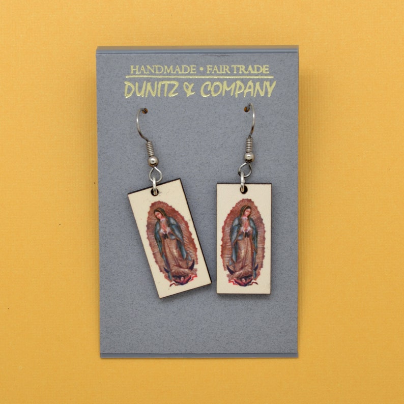 This shows our earrings on a grey earring card featuring our Dunitz & Company logo in metallic gold with the words handmade and fair trade.