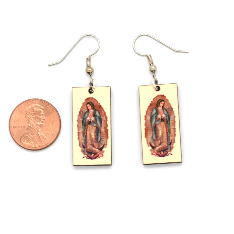 This shows our earrings on a grey earring card featuring our Dunitz & Company logo in metallic gold with the words handmade and fair trade. There is a USA copper penny in the photo for size comparison.