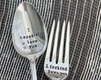May include: A silver spoon and fork with engraved messages. The spoon says "I cereal-ly love you" and the fork says "I forking love you".