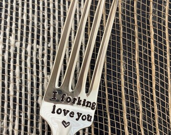 May include: Silver fork with the words "I forking love you" and a heart engraved on the handle.