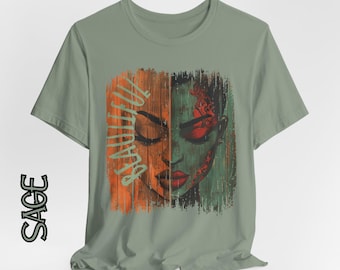 May include: Sage green t-shirt featuring a split-face graphic. One side is orange with the word "BEAUTIFUL" in a vertical script, the other side is green with red accents. The shirt has a crew neck and short sleeves.