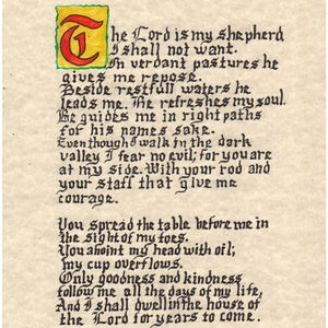 May include: Handwritten calligraphy of Psalm 23, "The Lord is my shepherd, I shall not want." The text is written in black ink on a cream-colored paper background. The first letter, "T", is a large illuminated capital letter in red and yellow.