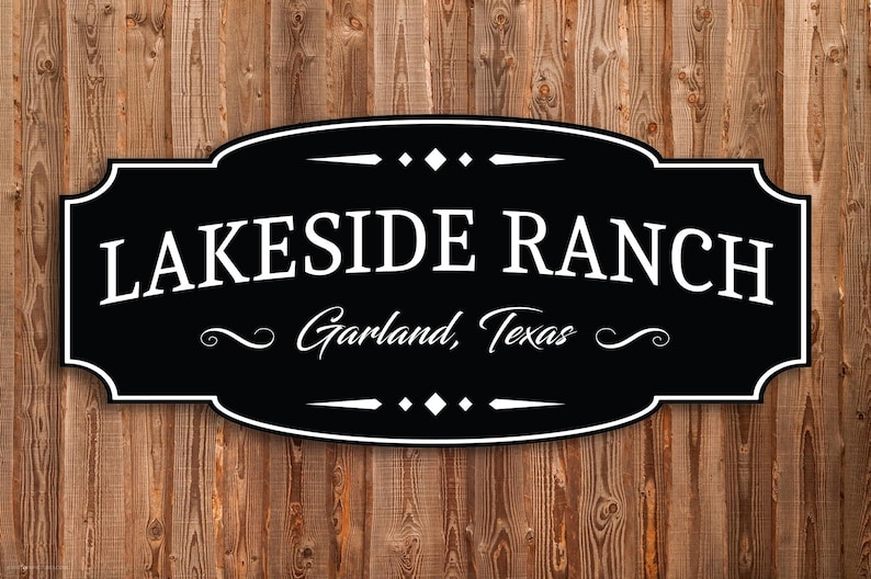 May include: A black and white sign with the text "LAKESIDE RANCH Garland, Texas" on a wooden background. The sign has a decorative border and embellishments.