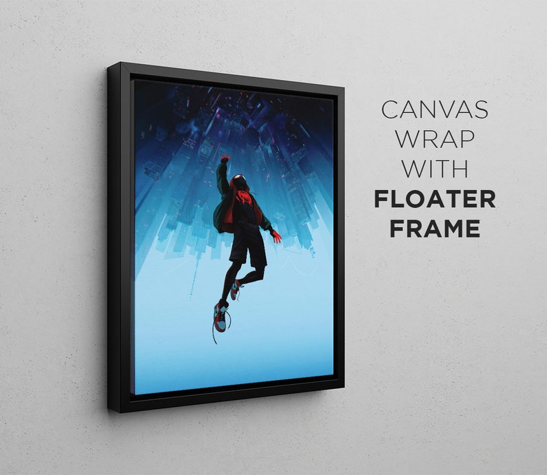 Op de afbeelding: Een canvas print met een zwarte zwevende lijst met daarop een persoon in een rood en zwart pak die in de lucht springt tegen een blauwe en witte stadsachtergrond.