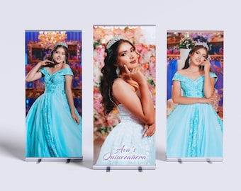 May include: Three roll-up banners showing a young woman in a light blue gown and a tiara. The banners have a floral background and the text "Ava's Quinceañera". The woman is posing in different positions.