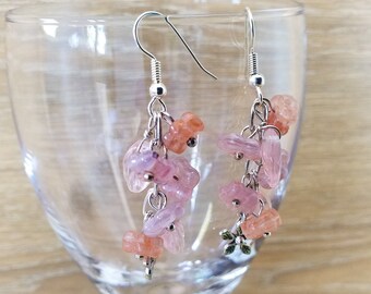 May include: Pink and orange gemstone dangle earrings with silver hooks. The earrings feature multiple small, irregular shaped gemstones.