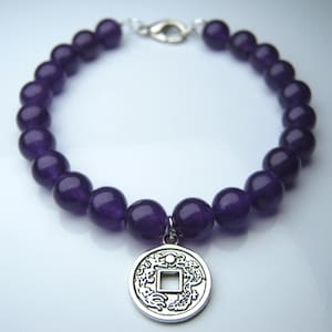 Purple candy dyed jade beaded bracelet with chinese good luck coin charm