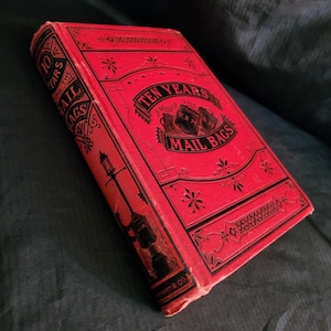 May include: A red hardcover book titled "Ten Years Among the Mail Bags". The book cover features a decorative design with black and white accents.