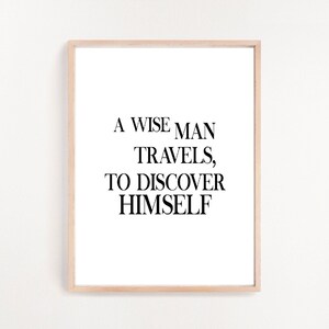 May include: A framed print with a black and white quote that reads "A wise man travels, to discover himself".