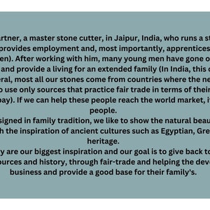 May include: Text on a light blue background describing a fair trade jewellery business that sources stones from countries where the need is great. The text mentions that the business provides employment and apprenticeships for young men. The text also mentions that the jewellery is designed in family tradition and is inspired by ancient cultures.