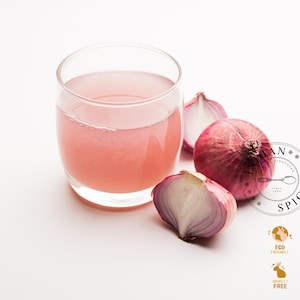 May include: A glass of pink liquid sits next to halved red onions on a white surface. The image includes a logo with text and icons indicating eco-friendly, vegan, and natural ingredients, cruelty-free, no animal testing, and paraben-free.