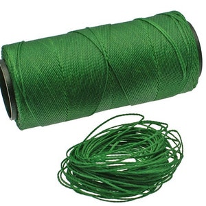 May include: A spool of green waxed cotton cord, wound on a black plastic bobbin. The cord is unwound and laid out in a loose circle.