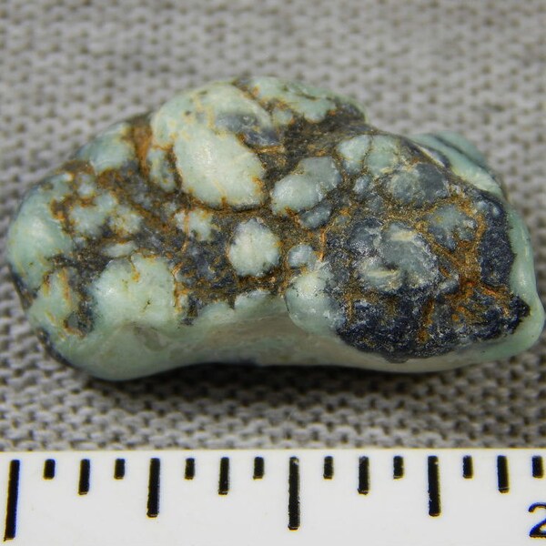 All  NATURAL  New Lander Turquoise  Medium  tumbled Nugget not stabalized or treated in any way. BEAUTIFUL Soft Colors  In BLACK Matrix.!!!