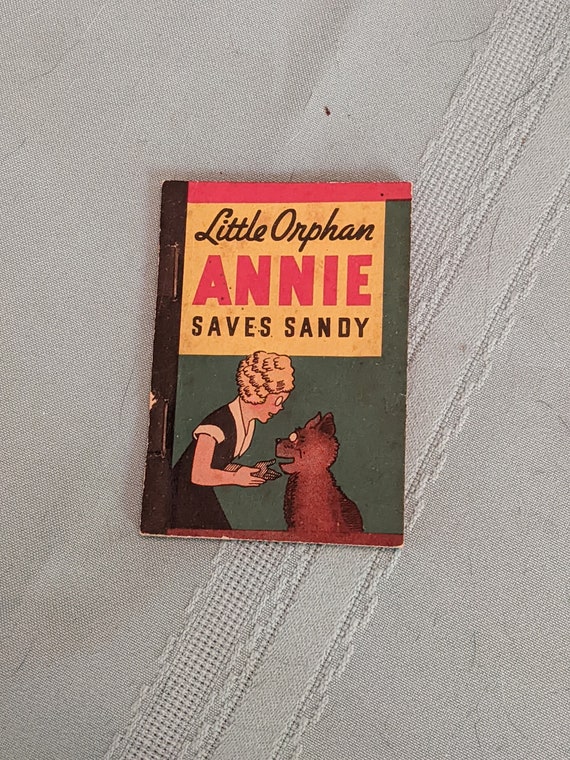 1938 Penny Book, Little Orphan Annie Saves Sandy. Bookworm Larvae Boring. Intact and Otherwise great Condition. Tiny Edge Nicks. INV#0601A