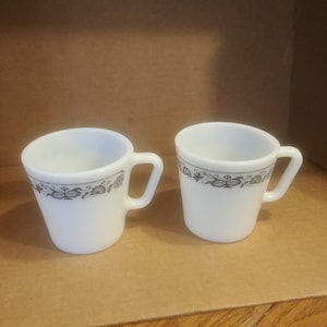 Pair, Pyrex White Floral Mugs with Blue Floral Bands #1410. Great Condition. No Wear to Graphics and No Damage. INV#0326