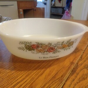 May include: White ceramic baking dish with a floral design and the text "Le Bon Potager".