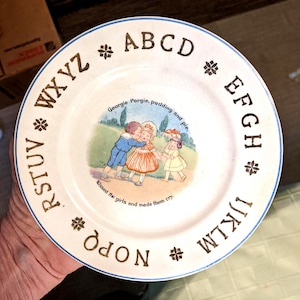 Cir 1910-30 Crown Pottery Co. 7-3/8" Child's Alphabet Plate, Georgie Porgie. Undamaged. Front and Back Crazing. Faint Back Mark. INV#0802