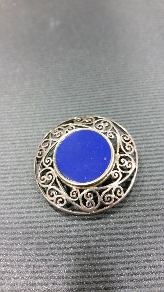 Sterling silver vintage brooch with deep blue ston