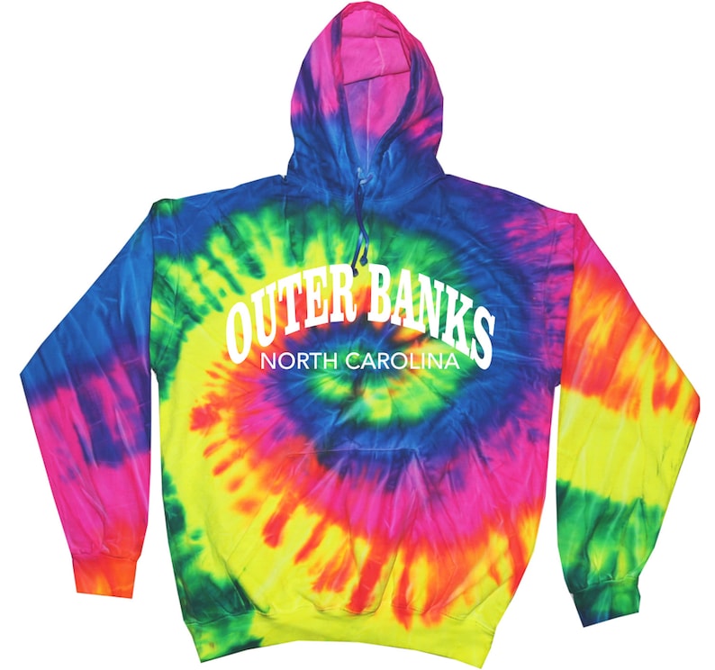 May include: A tie-dye hoodie with the text "Outer Banks North Carolina" in white. The hoodie features a spiral pattern of blue, green, yellow, pink, and purple. It has a hood and long sleeves.