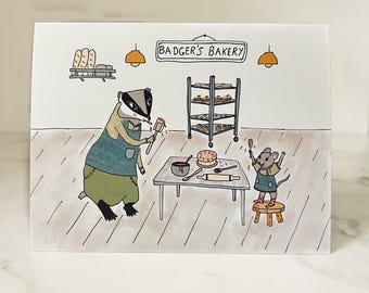 Puede incluir: Un tejón con un delantal verde y azul hornea un pastel con la ayuda de un ratón. El letrero de arriba dice "Badger's Bakery".
