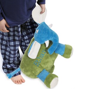 May include: A green and blue plush elephant toy with a white face and a white tail. The elephant is holding a green and blue blanket with the name "Ethan" embroidered on it.