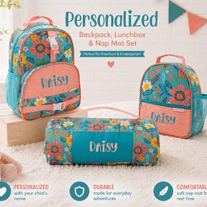 May include: A personalized backpack, lunchbox, and nap mat set. The set features a floral pattern in teal, coral, and yellow. The name "Daisy" is printed on the lunchbox, backpack, and nap mat. The set is designed for preschool and kindergarten.