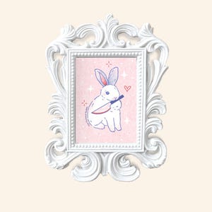 May include: A white rabbit with red eyes holds a knife in its paws. The rabbit is sitting on a pink background with white stars and a pink heart. The text "The Criminal Habits" is written in blue on the left side of the image.