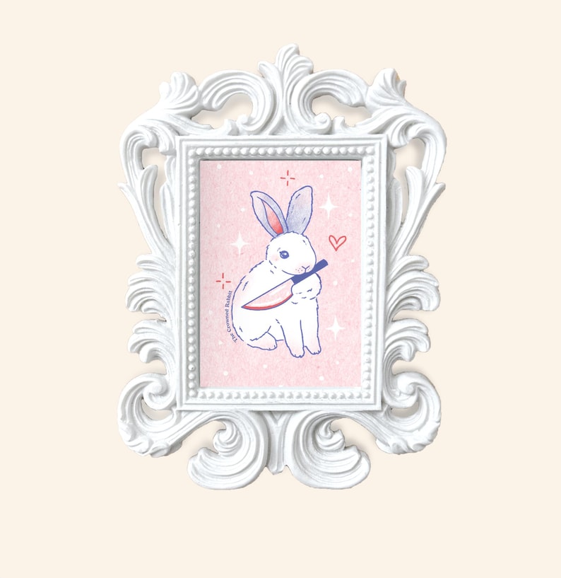 May include: A white rabbit with red eyes holds a knife in its paws. The rabbit is sitting on a pink background with white stars and a pink heart. The text "The Criminal Habits" is written in blue on the left side of the image.