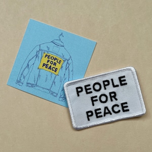 May include: A white patch with black text that reads "PEOPLE FOR PEACE". A blue denim jacket with a yellow patch that reads "PEOPLE FOR PEACE" is shown in the background.