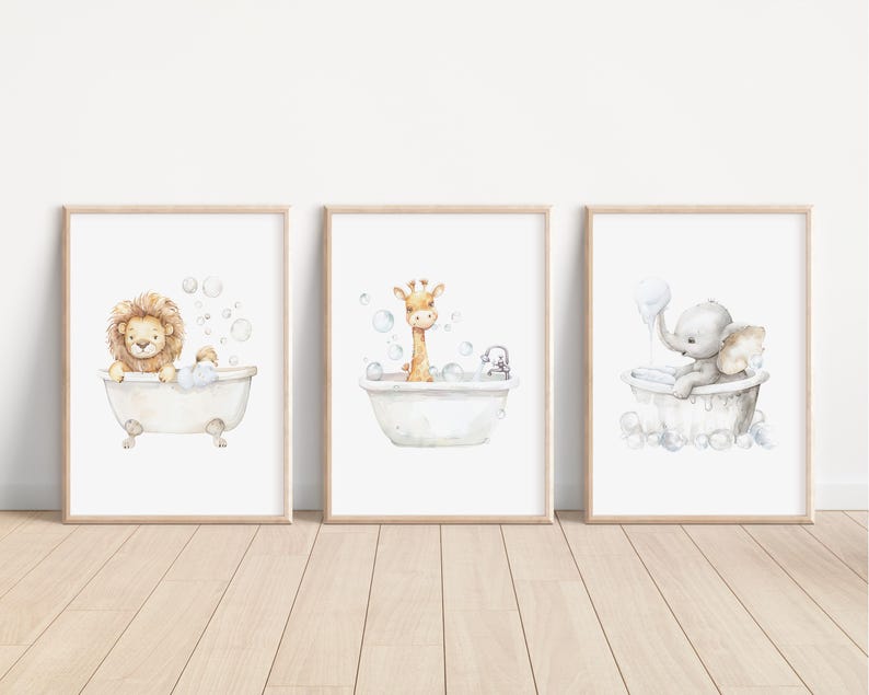 May include: Three framed watercolor prints featuring animals in bathtubs. A lion, giraffe, and elephant are depicted in vintage-style tubs with bubbles. The prints have a light wood frame and are set against a white background.