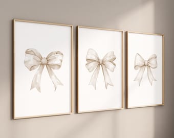 May include: Three framed prints with watercolor illustrations of beige bows on a white background.