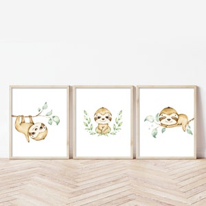 May include: Set of three watercolor sloth prints with green leaves. Each print features a different sloth pose, including hanging upside down, sitting, and sleeping.