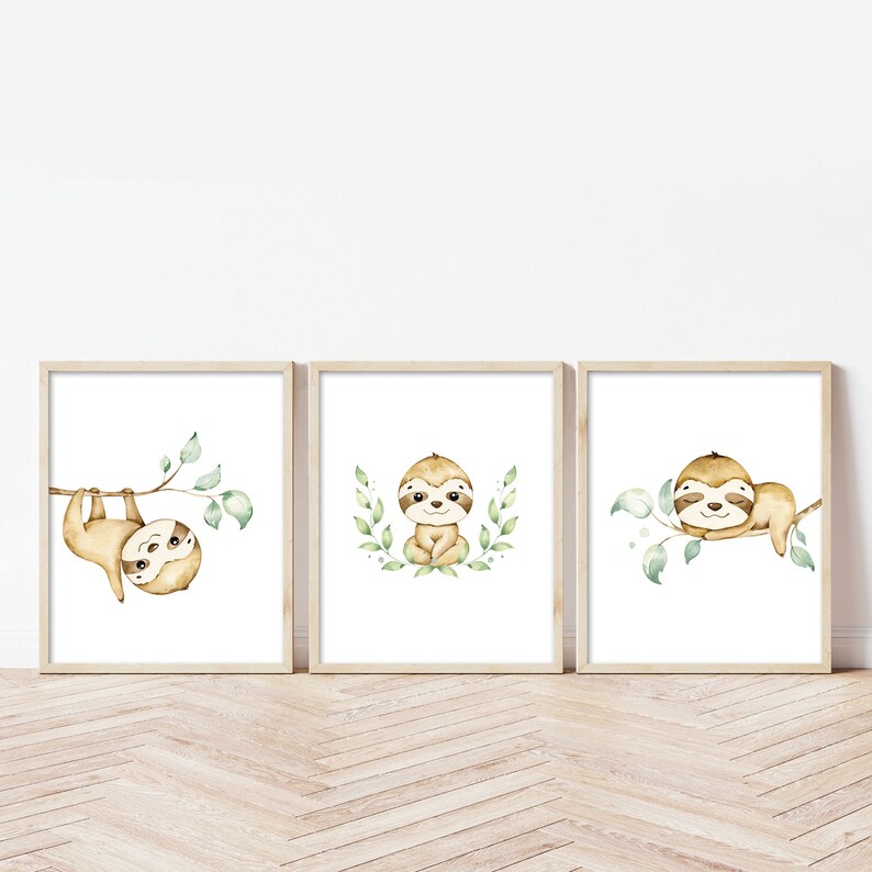 May include: Set of three watercolor sloth prints with green leaves. Each print features a different sloth pose, including hanging upside down, sitting, and sleeping.